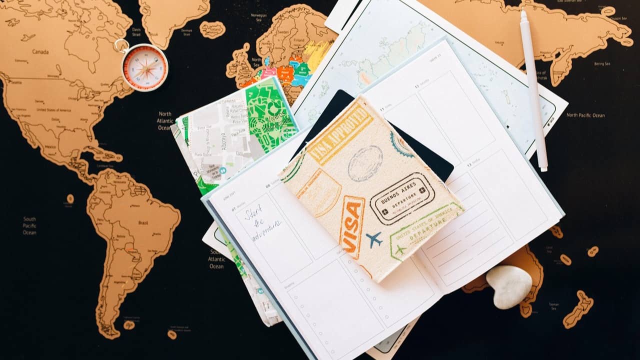 Travel documents and a smartphone for FIFA Pass and World Cup 2026 visa planning.