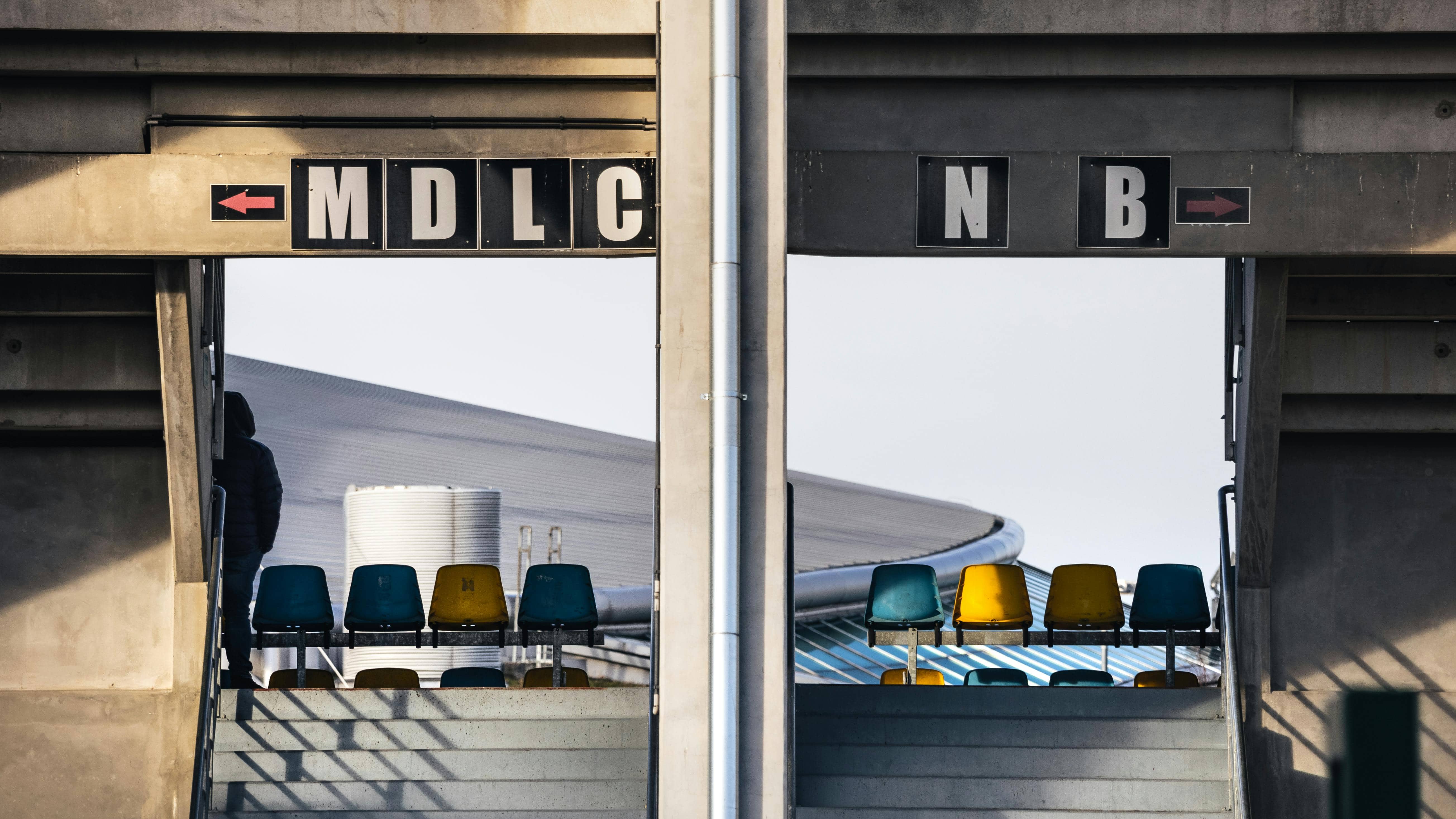 Concrete stadium entry corridor and seating, matching a World Cup 2026 mobile tickets and matchday-entry explainer.