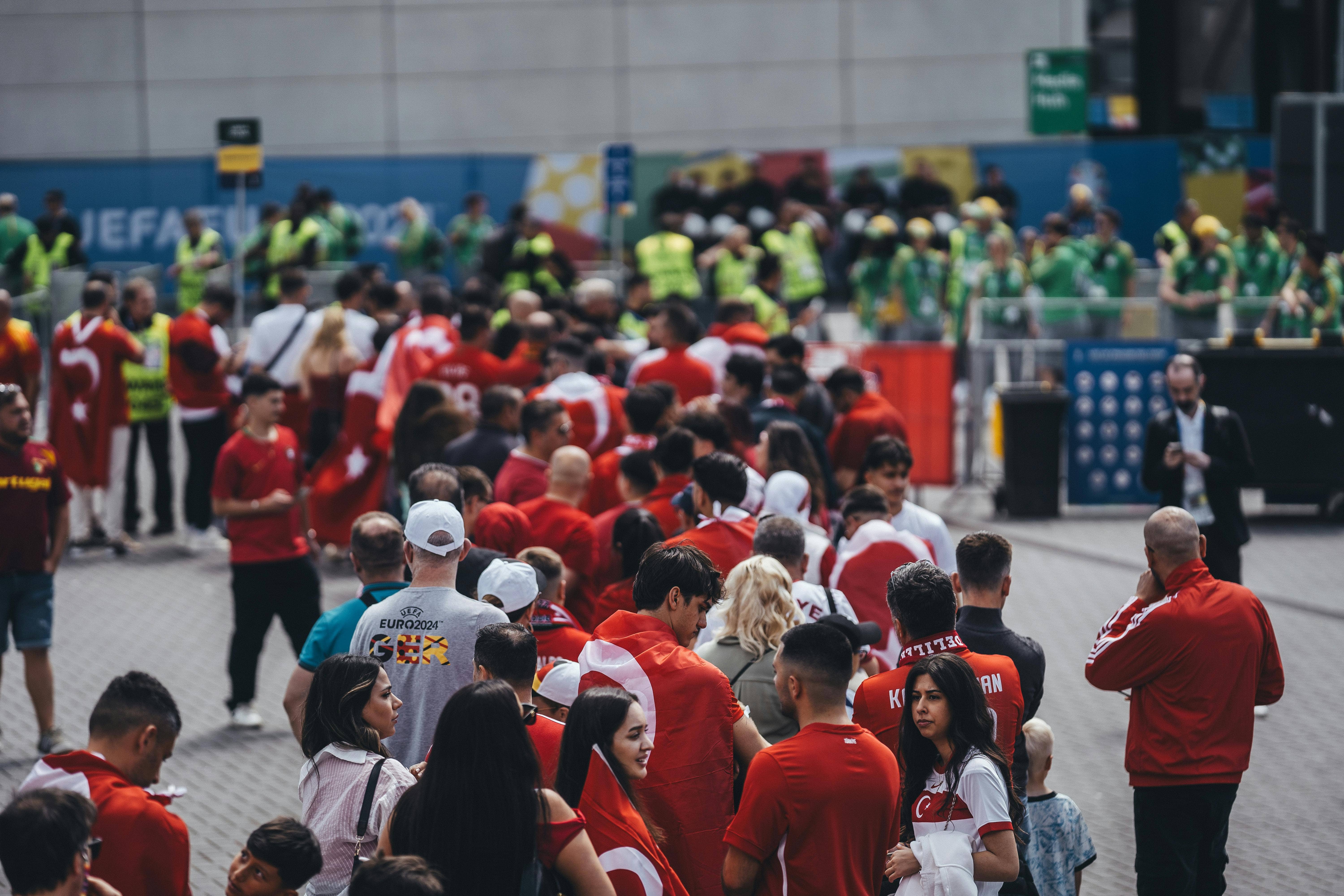 Fans queue outside a football stadium before buying World Cup 2026 tickets.